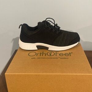 Women’s black and white orthopedic sneakers.